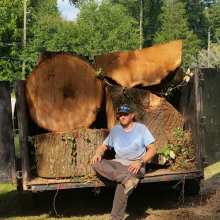 Portrait of the Owner in Front of Tree Stumps